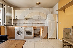 Image of kitchen front with cherry cabinets below and light cabinets above