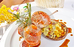 Image of lamb chops on a bed of vegetables Eggplant stuffed with vegetables