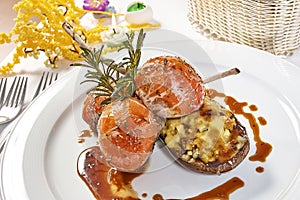 Image of lamb chops on a bed of vegetables Eggplant stuffed with vegetables