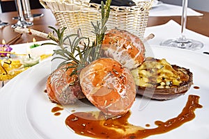 Image of lamb chops on a bed of vegetables Eggplant stuffed with vegetables