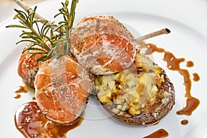 Image of lamb chops on a bed of vegetables Eggplant stuffed with vegetables