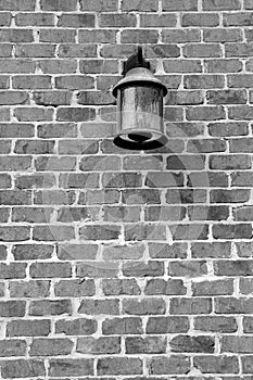 Image of lantern on old,weathered brick wall