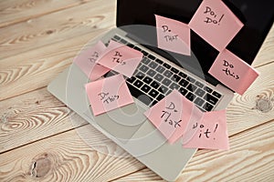 Image of laptop full of sticky notes reminders on screen. Work overload concept image. Coworking or working at home concept image