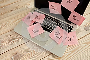 Image of laptop full of sticky notes reminders on screen. Work overload concept image. Coworking or working at home concept image