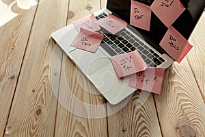 Image of laptop full of sticky notes reminders on screen. Work overload concept image. Coworking or working at home concept image