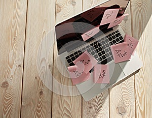 Image of laptop full of sticky notes reminders on screen. Work overload concept image. Coworking or working at home concept image