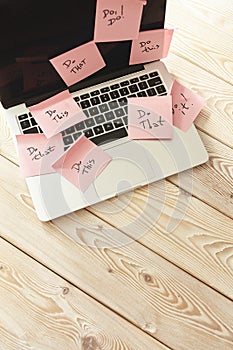 Image of laptop full of sticky notes reminders on screen. Work overload concept image. Coworking or working at home concept image