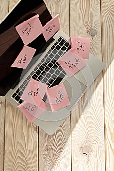 Image of laptop full of sticky notes reminders on screen. Work overload concept image. Coworking or working at home concept image