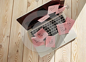 Image of laptop full of sticky notes reminders on screen. Work overload concept image. Coworking or working at home concept image