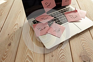 Image of laptop full of sticky notes reminders on screen. Work overload concept image. Coworking or working at home concept image