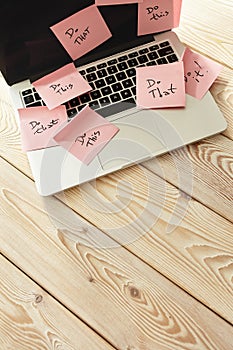 Image of laptop full of sticky notes reminders on screen. Work overload concept image. Coworking or working at home concept image