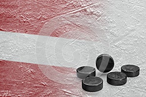 The image of the Latvian flag with hockey pucks
