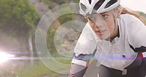 Image of light spots over caucasian woman cycling