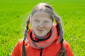 An image of little girl in green field