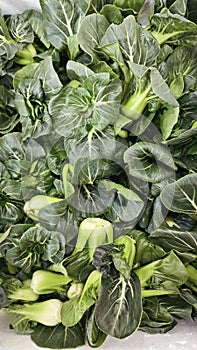 looking down on the stack of fresh green pak choi vegetable