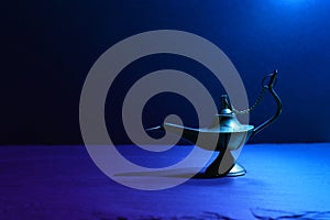 Image of magical mysterious aladdin lamp. Dark background and dramatic light