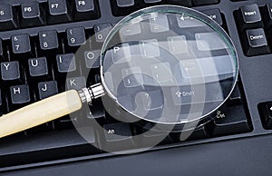 Image of Magnifying glass on an black keyboard