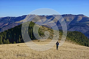 Image of a man flying a drone in the mountains.