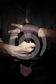 Image of man getting ready for office fight with a tie on his fist