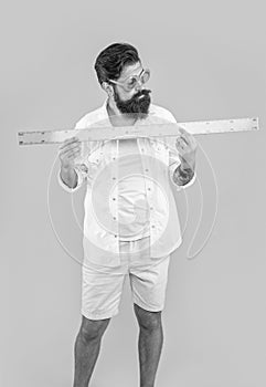image of man hold measuring ruler. man hold measuring ruler isolated on yellow.