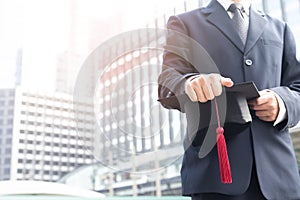 Image of a man holding a cap to receive a certificate