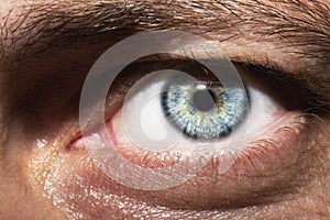 Image of man`s blue eye close up