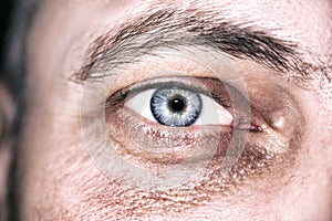 Image of man`s blue eye close up