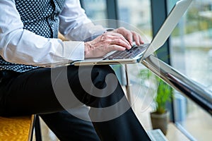 Image of man& x27;s hands typing on laptop. Man in suit. Selective focus. Business concept.