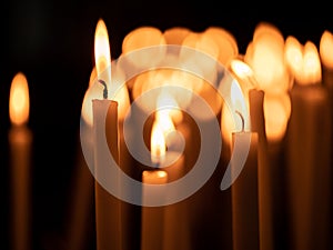 Image of many burning candles with shallow depth of field photo