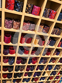 Many rolled up ties in a shop