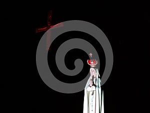 Image of Mary and crucifix in a dark room