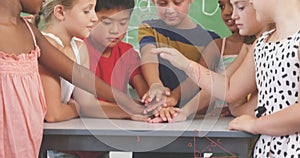 Image of math formulas over diverse pupils at school