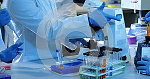 Image of mathematical equations over group of scientists in lab