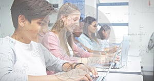 Image of mathematical formulas over students using computers