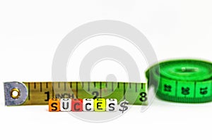 Image of measuring  success concept in life and business. Colorful alphabet beads spelling