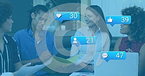 Image of media icons over caucasian using computer