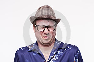 Image of a mid adult man in Hawaiian shirt making a face
