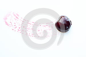 Image mouth with sweet cherry on a white surface.