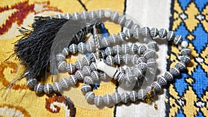 Image of Muslim prayer bead on prayer mat