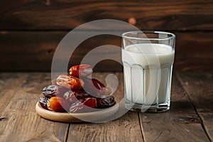 Image Neat arrangement of dates next to a glass of milk on the kitchen table