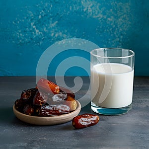 Image Neat arrangement of dates next to a glass of milk on the kitchen table