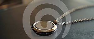An image of a necklace with a tiny discreet sensor attached to it. The sensor is designed to measure the mothers photo