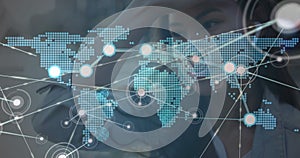 Image of network of connections with world map over woman using smartphone