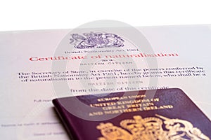 Image of the new issued pre brexit style British passport with naturalization certificate