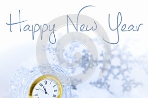 Image for New Year includes the face of a clock nearing twelve o`clock and sparkly accent pieces.