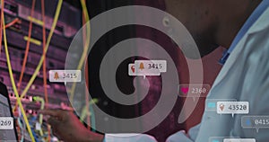 Image of notification bars, african american engineer checking data server system using laptop