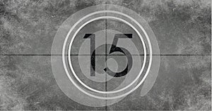 Image of number fifteen in vintage black and white film projector countdown on aged grey background