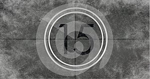 Image of number fifteen in vintage black and white film projector countdown on aged grey background