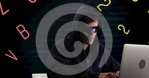 Image of numbers and letters over caucasian hacker using computer
