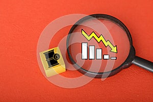 The image of an oil barrel juxtaposed with a graph arrow pointing downward symbolizes the impact of economic recession on the oil